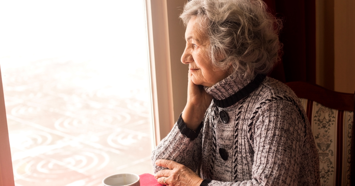 Lonely Senior Woman Sitting at Table