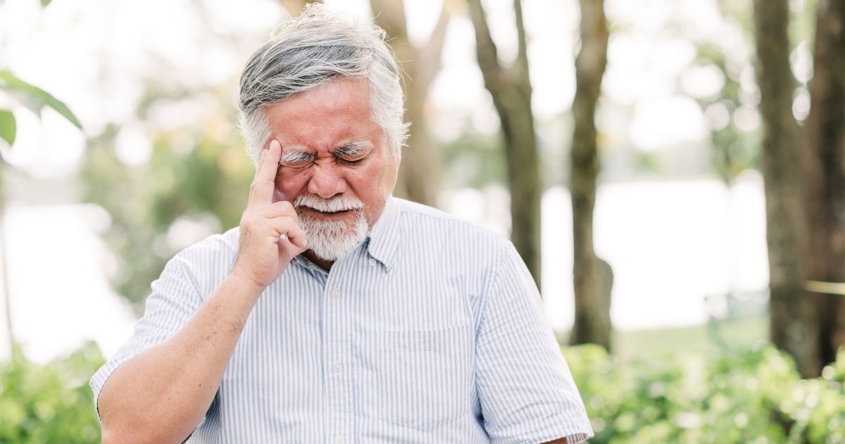 A headache is one of the signs of dehydration in seniors.