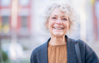 A woman in happy despite dealing with senior incontinence.