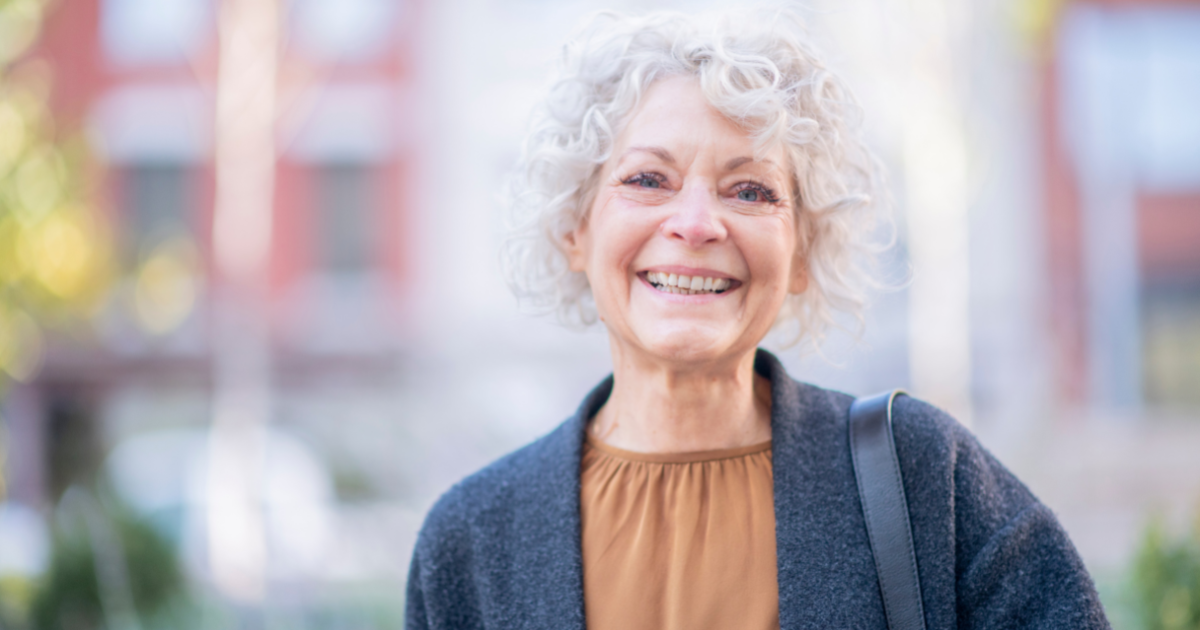 A woman in happy despite dealing with senior incontinence.