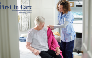 A professional caregiver helps a senior client get her coat on and get ready for the day.