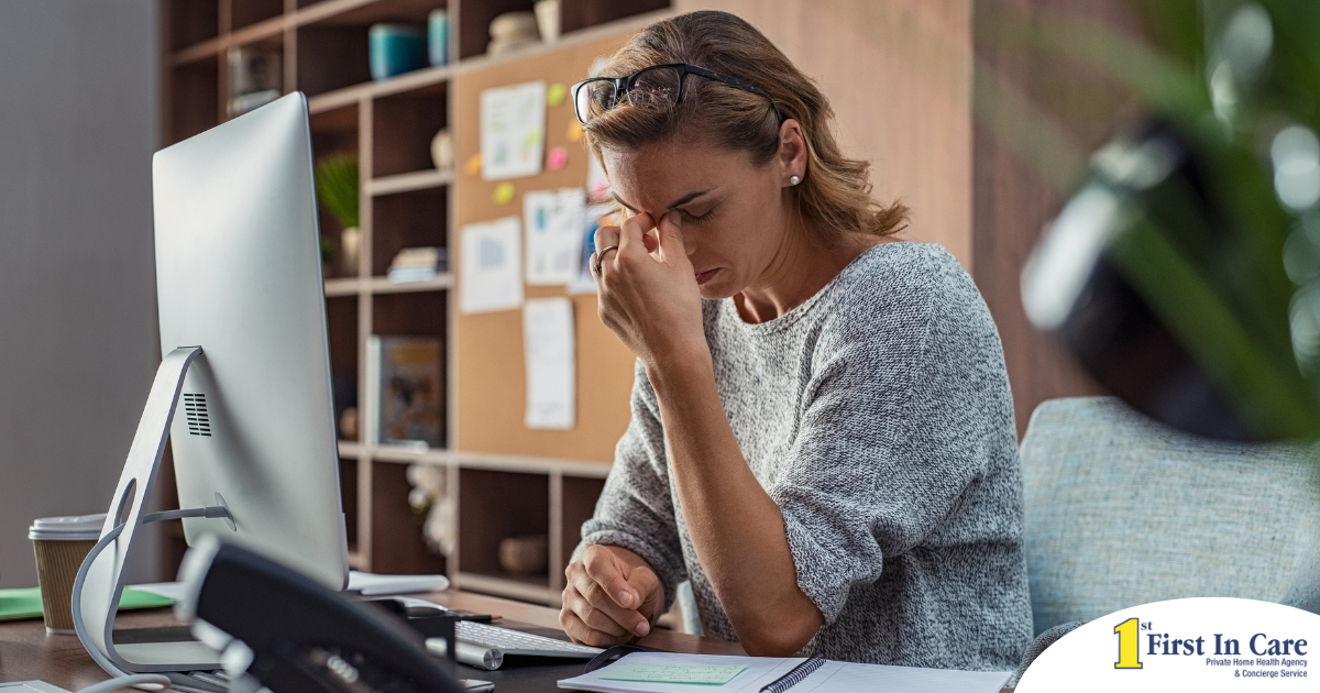 A woman is exhausted at her job as a result of struggling with balancing caregiving and her career.