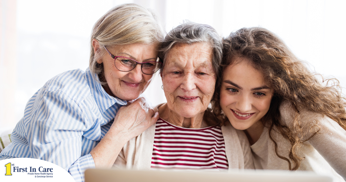 Three generations embrace and look at a computer, representing the sandwich generation.