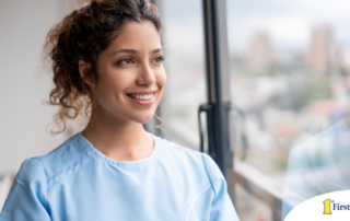 A woman in scrubs smiles, representing the satisfaction that can come with transitioning into a professional caregiving career.