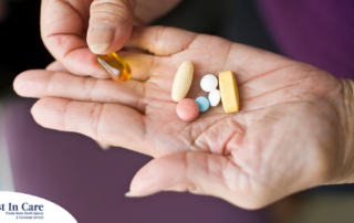 A woman holds pills in her hand, representing medication management.