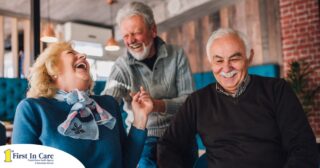 Older adults laugh and enjoy each other’s company representing how socialization can help seniors.