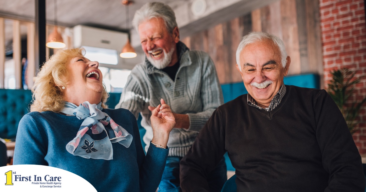 Older adults laugh and enjoy each other’s company representing how socialization can help seniors.