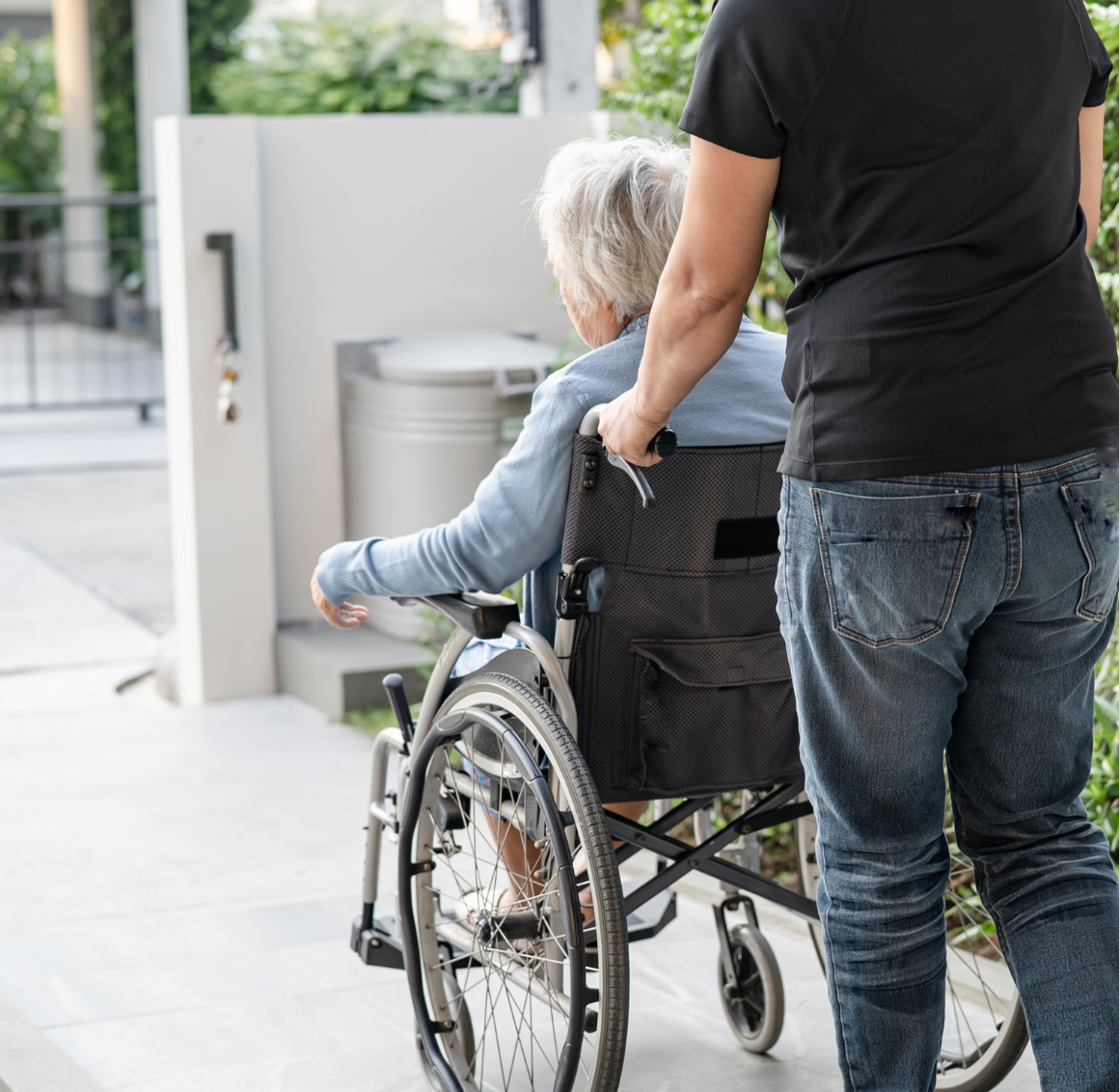 Transportation in Bradenton A man in a black shirt pushing an elderly woman in a wheel chair. Transportation in Bradenton