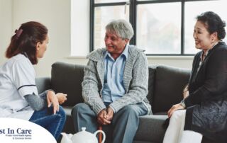 A caregiver talks with an elderly couple representing the kind of communication that professional caregivers need to have to anticipate client needs.
