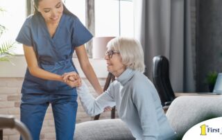 A caregiver demonstrates her caregiver skills by helping an older adult get up.