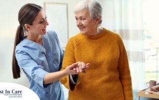 A caregiver helps a client get around, demonstrating one of the job duties of a caregiver.