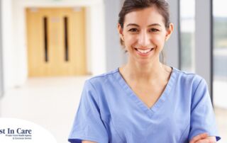 A woman in scrubs smiles, representing the good results that can come when caregivers branch out to become CNAs.