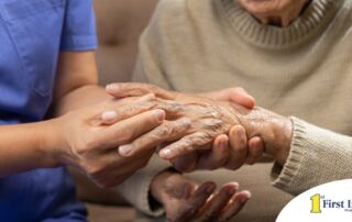 A care provider examines an older adult’s fingers, representing what would happen in an examination for rheumatoid arthritis.