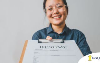 A woman happily hands in a resume, representing a successfully written caregiver resume.